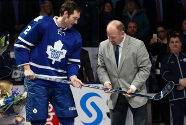 Former Maple Leaf Wendel Clark (R) presents Eric Brewer with a silver stick for 1,000 gamers service in the NHL before the game in Toronto on Monday March 23, 2015. Jack Boland/Toronto Sun/QMI Agency