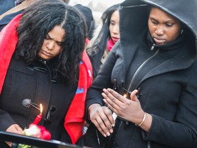 Trevor Seraphine's sisters light candles during a vigil for the slain teen Monday March 23, 2015. (Dave Thomas/Toronto Sun)