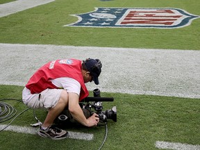 A cameraman films the Atlanta Falcons during a game against the Houston Texans August 16, 2014 at NRG Stadium in Houston, Texas. (Thomas B. Shea/Getty Images/AFP)