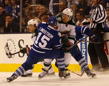 Minnesota Wilds� Jason Pominville (29) R and Toronto Maple Leafs� Joakim Lindstrom (15) D ��collide during the third period. Wild defeat the Maple Leafs 2-1 in Toronto on Monday March 23, 2015. Jack Boland/Toronto Sun/QMI Agency