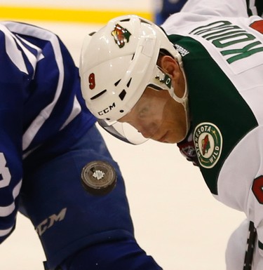 Minnesota Wilds� Mikko Koivu (9) C has his eye on the puck during a face-off during the third period. Wild defeat the Maple Leafs 2-1 in Toronto on Monday March 23, 2015. Jack Boland/Toronto Sun/QMI Agency