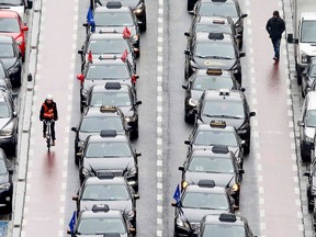 Taxi drivers line a street during a protest against online ride-sharing company Uber, in central Brussels, March 3, 2015. (REUTERS/Yves Herman)