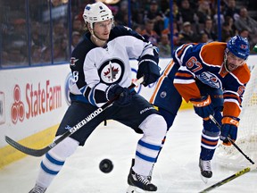 Benoit Pouliot chases Winnipeg’s Jacob Trouba during the second period of Monday’s game at Rexall Place. (Codie McLachlan, Edmonton Sun)