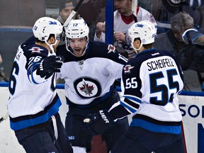 Winnipeg's Blake Wheeler (26), Drew Stafford (12) and Mark Scheifele (55) celebrate Stafford's goal during the first period of the Edmonton Oilers' NHL hockey game against the Winnipeg Jets at Rexall Place in Edmonton, Alta., on Monday, March 23, 2015. Codie McLachlan/Edmonton Sun/QMI Agency