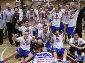 Members of the Oak park Raiders boys`basketball team celebrate their 68-67 overtime victory over the St. Paul`s Crusaders in the provincial high school basketball championship final, Monday, March 23, 2015, at the Duckworth Centre.
RUSTY BARTON, For the Winnipeg Sun