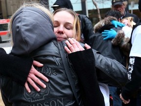 The parents of Meika Jordan hug supporters before marching to Calgary Courts as trial begins in the death of their daughter in Calgary, Alta. on Monday March 23 2015. Darren Makowichuk/Calgary Sun/QMI Agency
