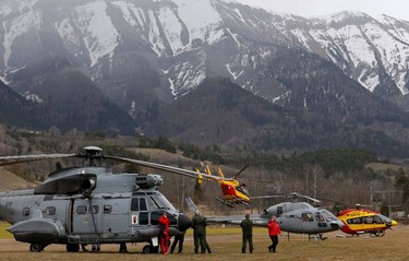 Rescue helicopters from the French Securite Civile and the Air Force are seen in front of the French Alps during a rescue operation near to the crash site of an Airbus A320, near Seyne-les-Alpes, March 24, 2015. (REUTERS/Jean-Paul Pelissier)