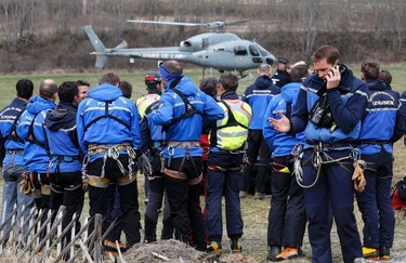 French Police and Gendarmerie Alpine rescue units gather on a field as they prepare to reach the crash site of an Airbus A320, near Seyne-les-Alpes, in the French Alps, March 24, 2015. (REUTERS/Jean-Paul Pelissier)