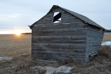 The sun sets in the distance behind a dilapidated out building on the corner of an acreage on Range Road 82 north of Wembley, Alberta Friday, January 13, 2011. DAN ILIKA/DAILY HERALD-TRIBUNE/QMI AGENCY