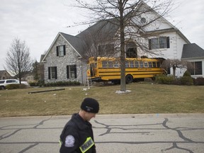 A school bus is pictured after it crashed into a house at the Windermere Development in Blue Bell, Pa., on March 24, 2015. (REUTERS/Mark Makela)