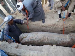 A wooden sarcophagus is lifted from the ground in Luxor, southern Egypt on Feb. 10, 2014, in this picture released by Egypt's Supreme Council of Antiquities on Feb. 13, 2014. The 3,600-year-old sarcophagus, which dates back to 1600 B.C. during the reign of the Pharaonic 17th Dynasty, was uncovered with a mummy still inside, according to Egypt's Antiquities Minister. (REUTERS FILES/Supreme Council of Antiquities/Handout via Reuters)