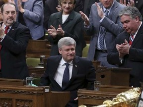 Prime Minister Stephen Harper receives a standing ovation from his caucus after speaking in the House of Commons on Parliament Hill in Ottawa March 24, 2015. REUTERS/Chris Wattie