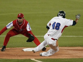 Cuban second baseman Hector Olivera (left) tags out Dominican Republic's Bernabet Castro (right) during a World Cup of Baseball qualifying tournament in San Juan, Puerto Rico in 2010. Olivera signed with the Dodgers on Tuesday, March 24, 2015. (Ana Martinez/Reuters/Files)
