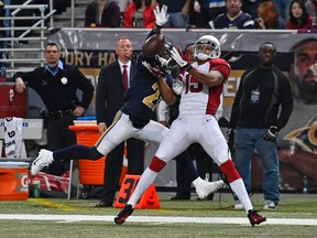 Rams cornerback Janoris Jenkins (21) is called for pass interference on Cardinals wide receiver Michael Floyd (15) during NFL action in St. Louis on Dec. 11, 2014. (Jasen Vinlove/USA TODAY Sports)