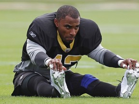 New Orleans Saints safety Darren Sharper stretches before practice at the University of Miami facility in Coral Gables, Florida in this file photo taken February 3, 2010.  (REUTERS/Jeff Haynes/Files)