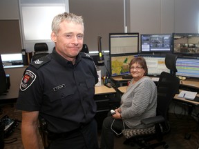 Kingston Police Sgt. Chris Bracken in the communications unit with communications officer Chris Peters, where local 911 calls are received at Kingston Police Headquarters. (Ian MacAlpine/The Whig-Standard)