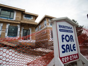 A Heritage Custom Homes infill development is seen west of 85 Street along 76 Avenue in the King Edward Park neighbourhood of Edmonton, Alta., on Sunday, Jan. 25, 2015. Infill development is underway in established neighbourhood across the Capital City and is regulated by the City of Edmonton. Ian Kucerak/Edmonton Sun