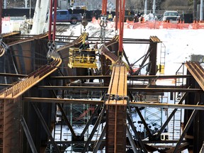 Workers inspect the bent metal on the 102 ave bridge in Edmonton, Alberta on Tuesday, March 24, 2015. The crew is preparing to lift the girders out. Perry Mah/Edmonton Sun