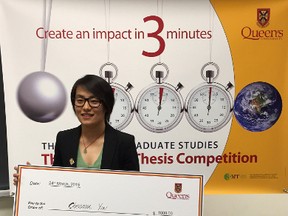 Chenman (Cara) Yin, winner of 3MT competition, with her prize money after presentation. (Alisa Howlett/For The Whig-Standard)