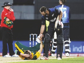 New Zealand’s Grant Elliot helps South Africa’s bowler Dale Steyn up after New Zealand won their World Cup semifinal. (REUTERS)