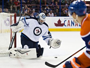 Edmonton's Taylor Hall (4) takes a shot on Winnipeg's goalie Ondrej Pavelec (31) during the second period of the Edmonton Oilers' NHL hockey game against the Winnipeg Jets at Rexall Place in Edmonton, Alta., on Monday, March 23, 2015. Codie McLachlan/Edmonton Sun/QMI Agency