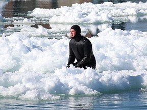 Curt Brown, 32, rides an ice floe on the St. Clair River Sunday. Brown was spotted doing the same thing Saturday night and ended up being the focus of a police, fire and coast guard search. (TYLER KULA/ THE OBSERVER/ QMI AGENCY)