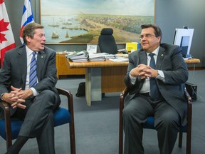 Toronto Mayor John Tory (left) sits in his office with visiting Montreal Mayor Denis Coderre at City Hall in Toronto Wednesday March 25, 2015. (Ernest Doroszuk/Toronto Sun)
