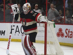 Ottawa Senators goalie Andrew Hammond watches hamburgers fly on to the ice after the Senators scored late in the third period against the Boston Bruins at the Canadian Tire Centre in Ottawa Thursday March 19,  2015. The Ottawa Senators defeated the Boston ruins 6-4.  Tony Caldwell/Ottawa Sun/QMI Agency