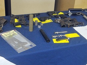 Weapons and piece of weapons confiscated in a raid on a Quebec location are on display at a press conference where police and military for four different agencies identify an international gun parts trafficking operation. Police arrested a 36 year old airman David Theriault at CFB Borden.
(J.T. MCVEIGH/QMI AGENCY)