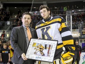 In recognition of setting three franchise records, Kingston Frontenacs goalie Lucas Peressini receives from executive director of business Justin Chenier a framed photograph before the final home game of the regular season on  March 20. The three records were: five shutouts in a season, a goals-against average of 2.32 and a save percentage of .922. (Julia McKay/The  Whig-Standard)