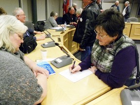 Quinte West resident Sharon Urquhart signs up to volunteer with Our TMH following a meeting at city hall in Trenton Wednesday night. The call has gone out to the community to get involved with the community engagement process mandated by the province to help determine the future of Trenton Memorial Hospital. Community involvement is "crucial," said Our TMH chair Mike Cowan.
