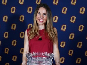 Kingston’s Liz Boag stands behind the PHE ‘55 Alumnae Trophy, awarded to her for being named Queen’s University’s top female athlete. (Ian MacAlpine/The Whig-Standard)