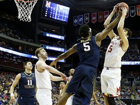 Scenes like this — West Virginia’s Devin Williams giving Maryland’s Michal Cekovsky no space last week in third-round action — are common when the defence-first Mountaineers hit the floor. They’ll need more of the same tonight against unbeaten Kentucky. (AFP)