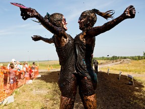 Sisters Breanna Martens and Jordann Muracz give each other a chest bump after completing the 5-km Dirty Donkey Mud Run at Springhill Winter Sports Park near Winnipeg, Man., in August 2014. Sarnia's Canatara Park will be the site June 13 of the Assante Dirty Dash for Rebound. (File photo/QMI Agency)