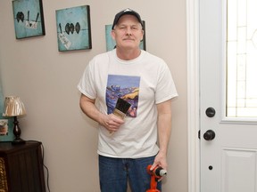 Bill Chrysler poses in his home with some of the tools he will use 	with his new handyman business The Finishing Touch.