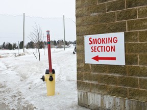 An arrow points to the designated smoking area at the Tim Horton Event's Centre.