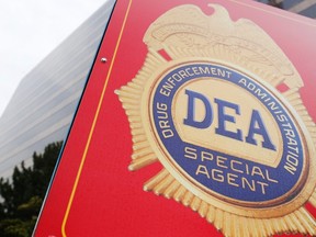 A sign with a DEA badge marks the entrance to the U.S. Drug Enforcement Administration (DEA) Museum in Arlington, Virginia, August 8, 2013. A secretive U.S. Drug Enforcement Administration unit is funneling information from intelligence intercepts, wiretaps, informants and a massive database of telephone records to authorities across the nation to help them launch criminal investigations of Americans.  REUTERS/Jonathan Ernst
