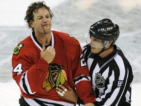 Nick Boynton of the Chicago Blackhawks gestures to Blair Jones of the Tampa Bay Lightning after a fight during NHL exhibition action in Winnipeg September 22, 2010. (REUTERS/Fred Greenslade)
