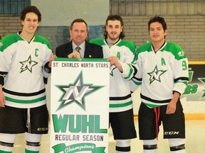 St. Charles North Stars players Scott Marshall (left), Shane Snow and Synee Coonishish receive the WUHL regular season banner from St. Charles mayor Paul Schoppmann. The North Stars play for the league title Friday.