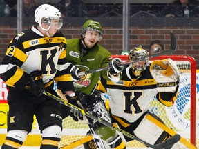 North Bay Battalion forward Ryan Kujawinski reaches to tip a shot from the point as Kingston Frontenacs defenceman Evan McEneny and goalie Jeremy Helvig defend during OHL action in North Bay on March 22. The Battalion won 6-0. (Dave Dale/QMI Agency)