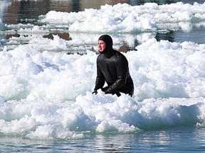 Curt Brown, 32, rides an ice floe on the St. Clair River Sunday. Brown was spotted doing the same thing Saturday night and ended up being the focus of a police, fire and coast guard search.

Tyler Cura/QMI Agency