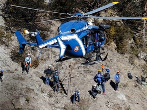 French gendarmes and investigators work amongst the debris of the Airbus A320 at the site of the Germanwings crash, near Seyne-les-Alpes, French Alps March 26, 2015.  (REUTERS/Emmanuel Foudrot)