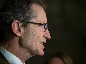 Alberta Liberal leader David Swann speaks with the media in the Alberta Legislature rotunda after Alberta finance minister Robin Campbell delivered Budget 2015 in the Alberta Legislature in Edmonton, Alta., on Thursday, March 26, 2015. Ian Kucerak/Edmonton Sun/ QMI Agency