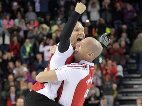 Skip Pat Simmons jumps into the arms of lead Nolan Thiessen after winning the Brier at the Scotiabank Saddledome in Calgary Sunday, March 8, 2015. (MIKE DREW/QMI AGENCY)