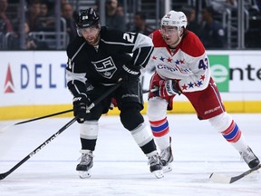 Jarret Stoll #28 of the Los Angeles Kings skates with the puck ahead of Tom Wilson #3 of the Washington Capitals at Staples Center on February 14, 2015 in Los Angeles, California. The Kings won 3-1.  Stephen Dunn/Getty Images/AFP