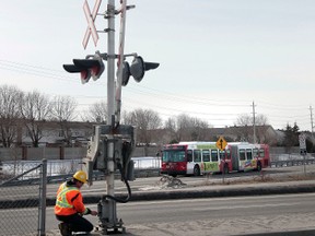 Via Rail repair crews work on malfunctioning signals at the Fallowfield Rd. crossing in Barrhaven on Friday morning in Ottawa On. Friday April 4,  2014. (Tony Caldwell/Ottawa Sun/QMI Agency)
