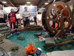 OTTAWA, ONT (27/03/15) Marci Faletti of Scherer Gardening, left, speaks with Heather MacLeod, middle, and Gillian Trojan at the 2015 Ottawa Home and Garden show . The show runs Mar. 26 through 29, 2015 at the EY Centre on Uplands Road. Andrew Meade/ Ottawa Sun