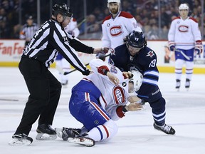 Winnipeg Jets centre Jim Slater (right) tussles with Montreal Canadiens defenceman Nathan Beaulieu during NHL action at MTS Centre in Winnipeg, Man., on Thu., March 26, 2015.