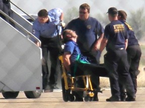 Clayton Osbon is removed from a JetBlue passenger jet in Amarillo, Texas in this March 27, 2012 file photo. (REUTERS/Steve Miller/The Reporters Edge/Files)