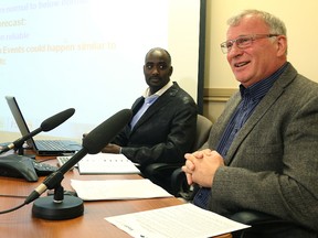 Manitoba flood forecasters Steve Topping (right) and  Fisaha Unduche speak to media during a conference at the Manitoba Water Stewardship office in Winnipeg, Man., on Fri., March 27, 2015.